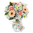This luminous bouquet brings a soft celebration of Hillingdon's garden heritage into any home or office. At its heart, peach-pink roses unfold in sumptuous spirals-their presence classic and tender, carrying the same sense of comfort as a leisurely stroll in Fassnidge Park. Sunny, peach-orange gerbera daisies with their distinctive deep centers punctuate the arrangement, offering cheerful energy and focus. Floating between these blooms, airy sprays of delicate baby's breath add fullness and movement, reminiscent of wisps of morning mist drifting over Minet Country Park. Plentiful white chrysanthemums with green-gold centers are tucked throughout, contributing fresh volume and a modern brightness. Touches of glossy eucalyptus foliage are arranged just so, heightening the bouquet's natural complexity and fragrance. Everything is anchored in a clear, gently ribbed glass vase-its simple profile keeping the spotlight on the flowers themselves. Wrapped around the neck, a rustic strand of twine holds a small white tag, blank and awaiting your own Wordsworthian note or special greeting. Perfect for same-day delivery around Hillingdon, from North Hillingdon to Yiewsley, this bouquet is a gentle expression of appreciation or joyous congratulations, sure to impart serenity and delight wherever it's displayed.